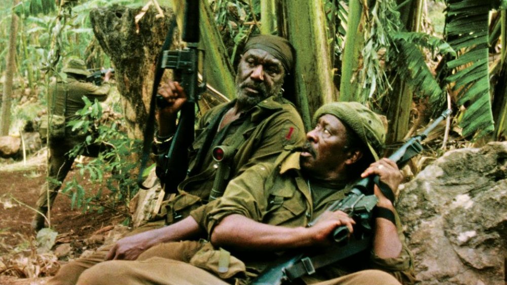 Clarke Peters as Otis crouching in the jungle in Da 5 Bloods