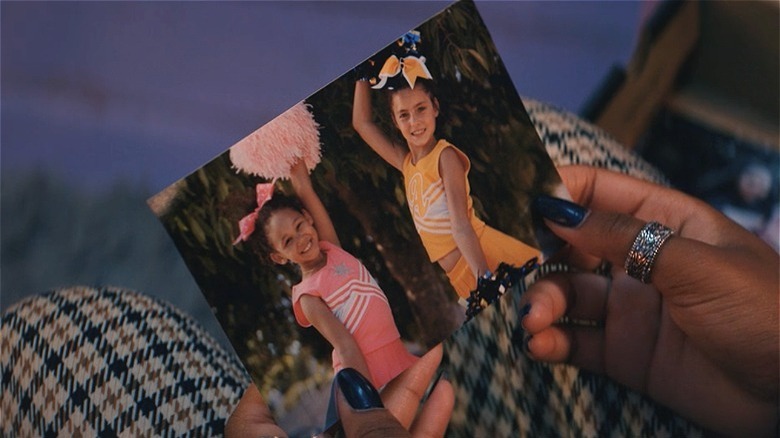 Hands holding a photo of two children