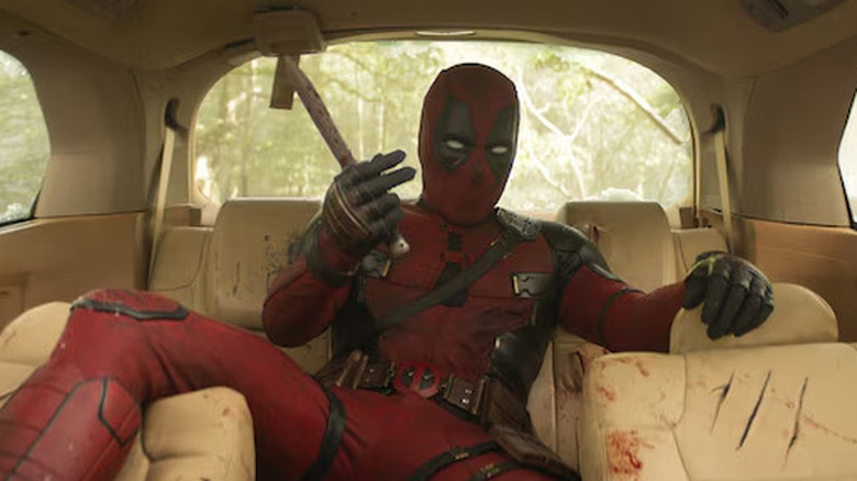 Deadpool in backseat of car