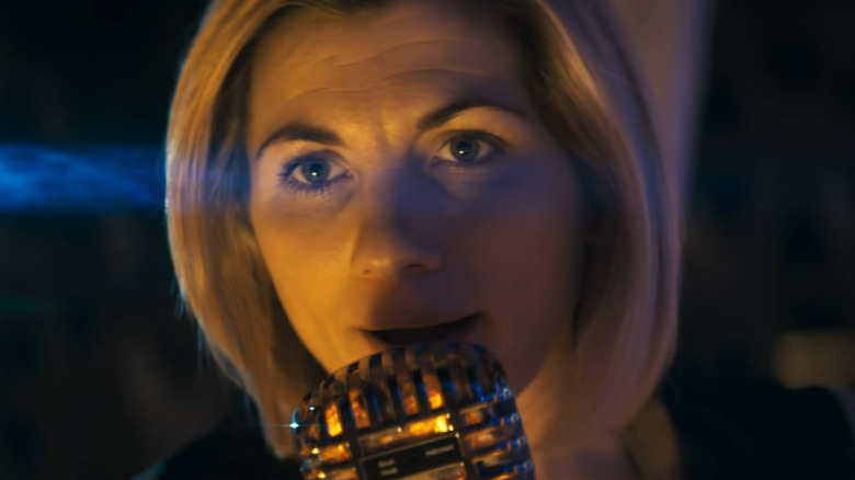 The 13th Doctor speaking into a microphone