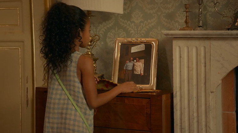 Idalia stares at a photo of her dad and the doctor