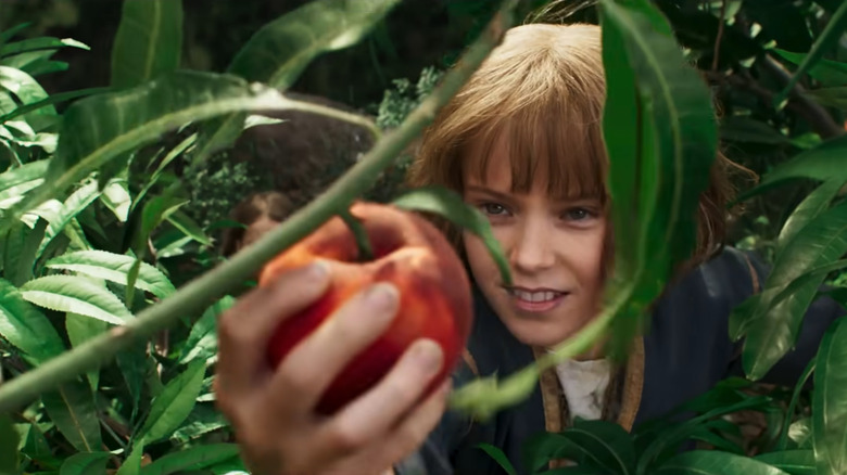 Young Furiosa grabs a fruit