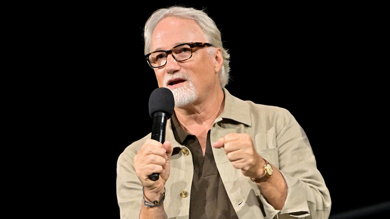 David Fincher holding a microphone