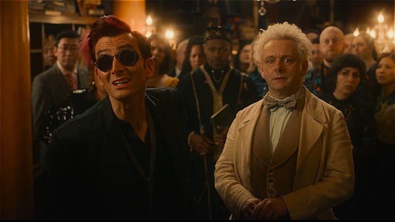 Aziraphale and Crowley standing in front of crowd