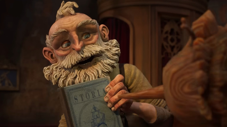 Geppetto showing Pinocchio Carlo's book