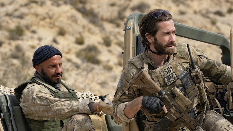 John and Ahmed sitting at a checkpoint