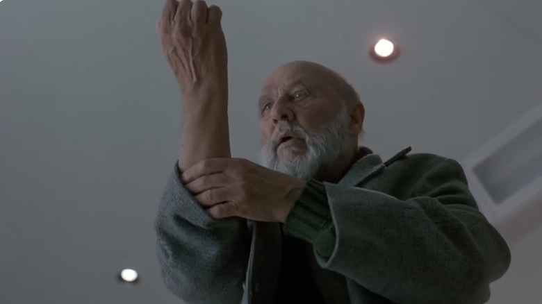 Loomis holds his arm in terror