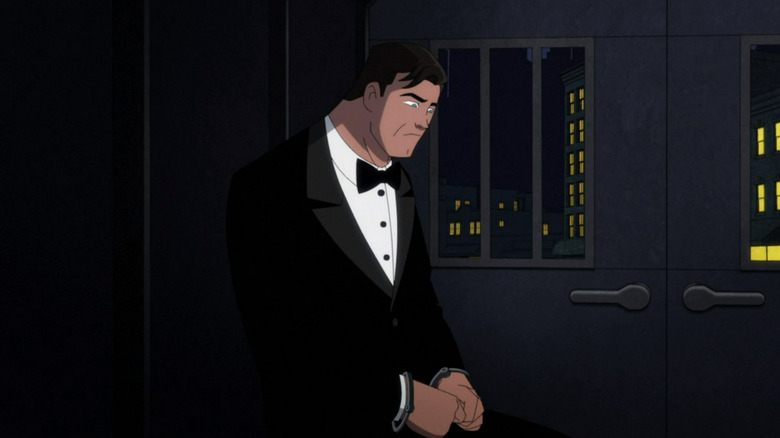 Bruce Wayne wearing handcuffs