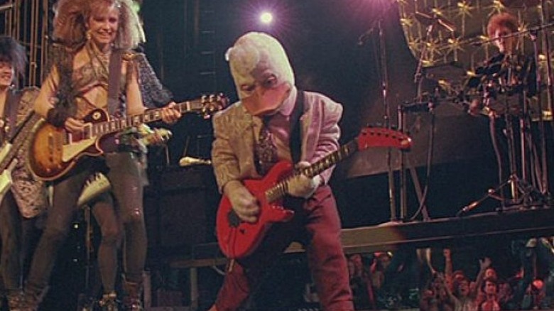 Howard the Duck playing guitar on stage