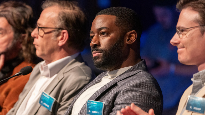 Byron sitting on a panel