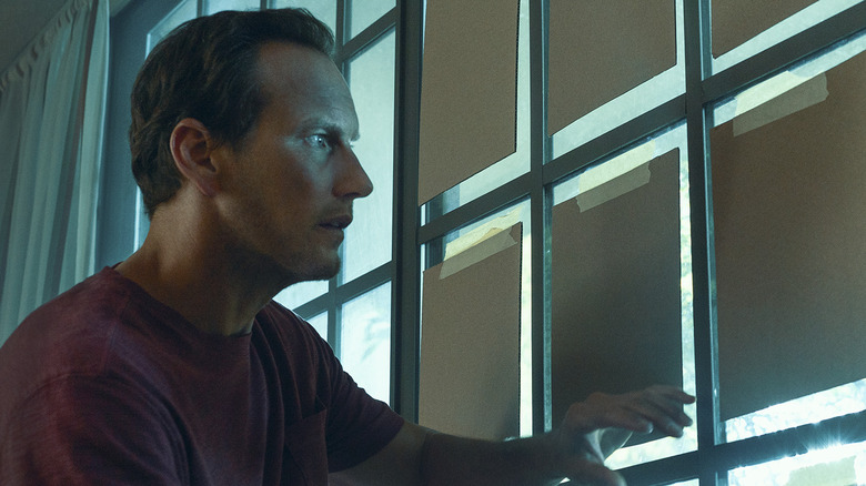 Patrick Wilson looking out of window