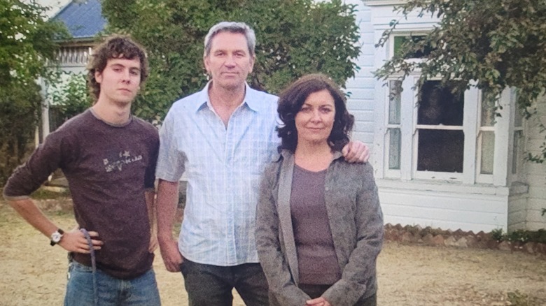 Mathew, Russell, June Palmer in front of house, Alice in window