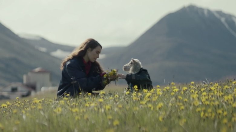 Noomi Rapace handing flower crown to Ada in Lamb movie