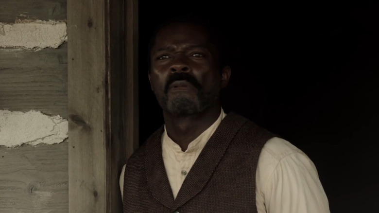 Bass Reeves stands in a doorway