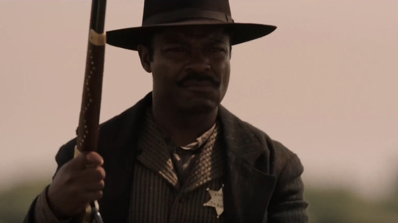 Bass Reeves holds a rifle