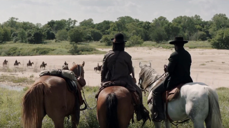 Reeves and Crow watch the freed men on horses