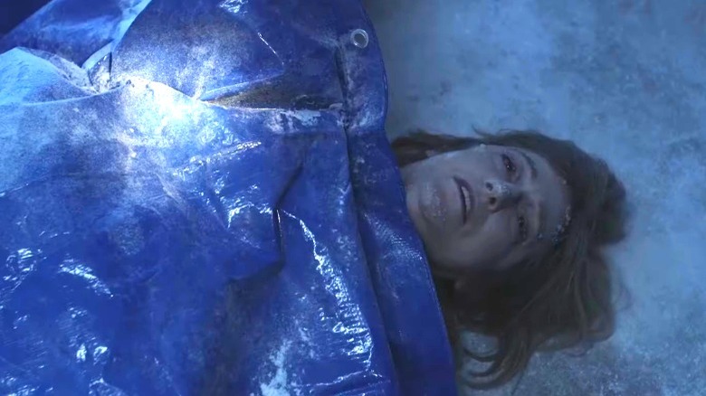 Dr. Fischer's body lying under tarp