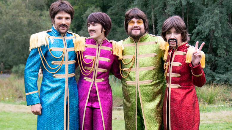 Mammals cast wearing Beatles costumes