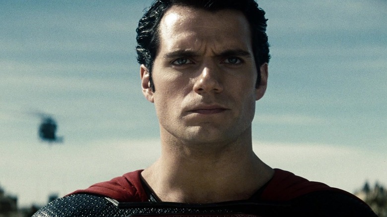 Superman stoically staring ahead with a helicopter behind him