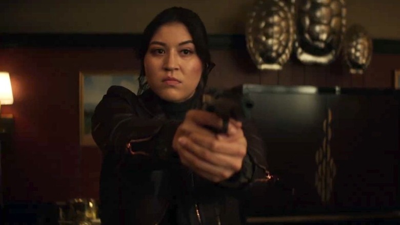 Maya holding a gun