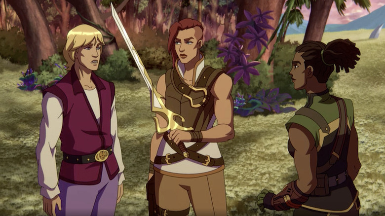 Prince Adam standing with Teela holding the Preturnian sword next to Andra