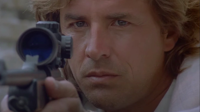 Crockett aims with a sniper rifle