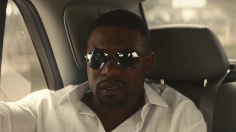 Trevante Rhodes sits in a car as Mike Tyson in "Mike"