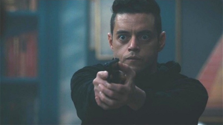 Elliot pointing gun with wide eyes