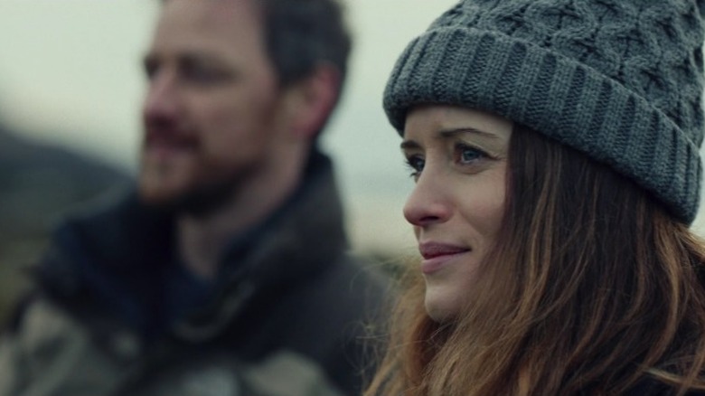 Close up of Clare Foy in knit hat with blurry James McAvoy in background