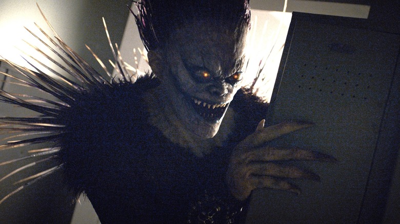 Ryuk holding book