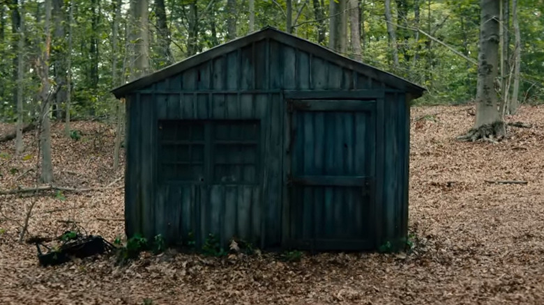 A wooden shed in a clearing