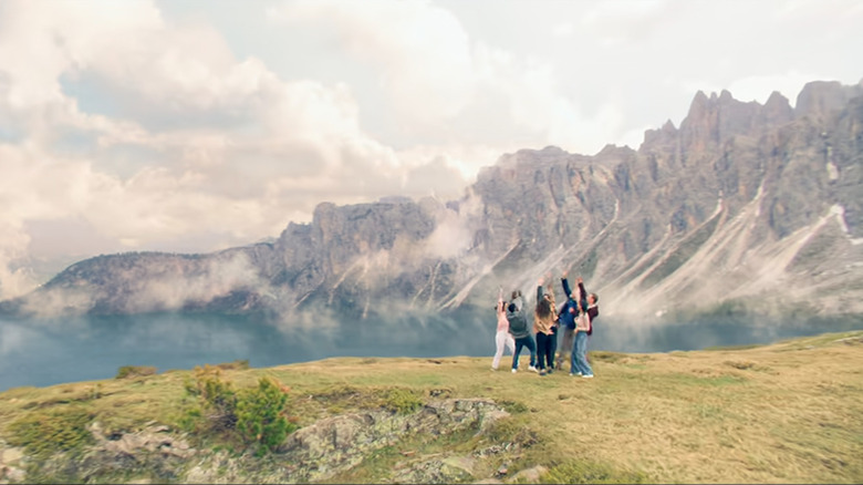 The crew celebrates on a hillside