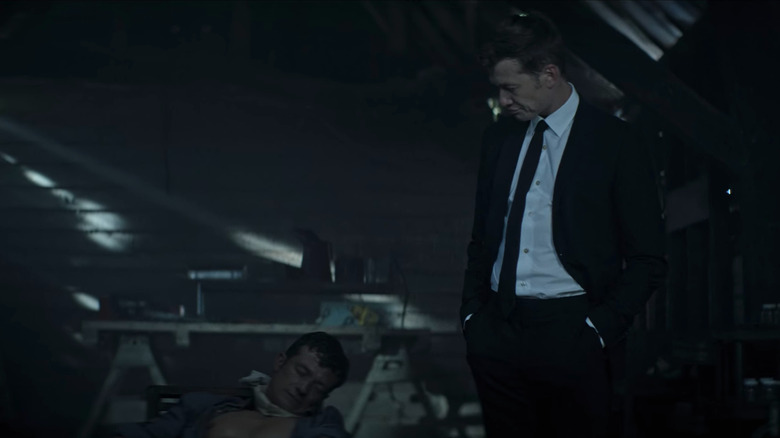 The fake Rhys examining the real Rhys' body