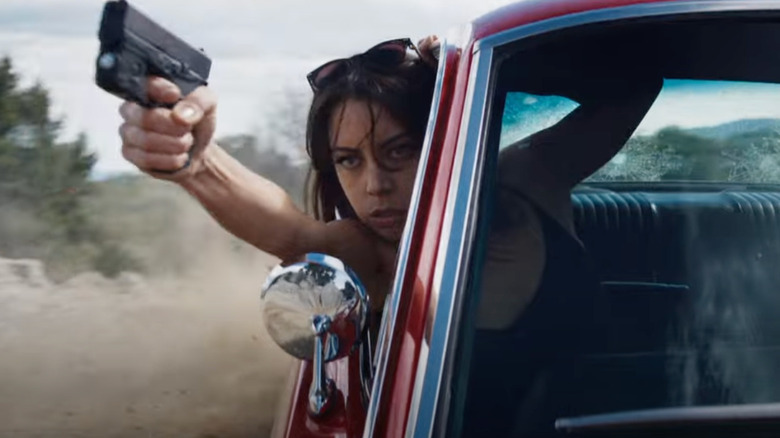 Aubrey Plaza firing at car