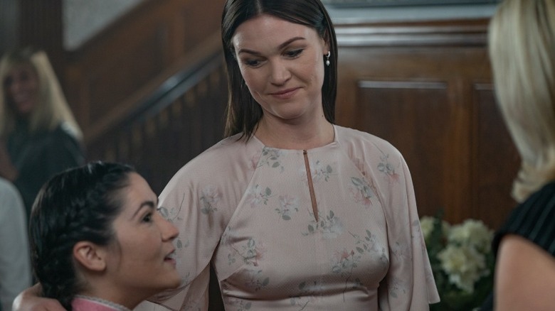 Leena and Tricia look cheerful while talking to a blonde woman