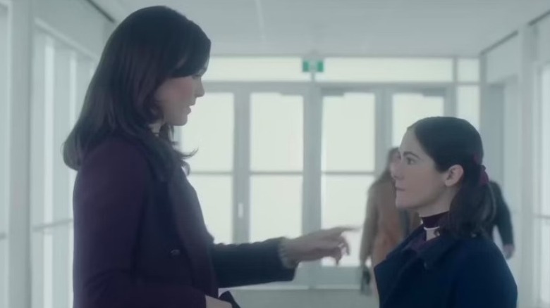 Tricia and Leena stand in a bright hallway, face to face