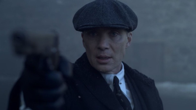 Tommy Shelby pointing a gun