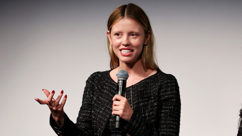 Mia Goth speaks into microphone