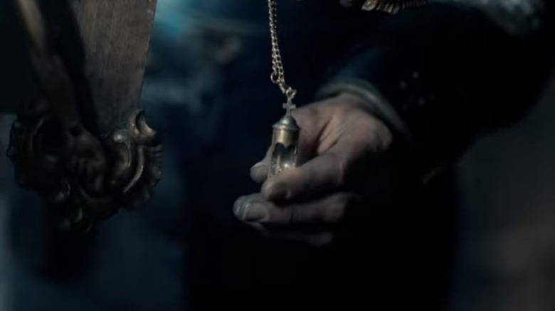 a hand pours a vial into gun barrell