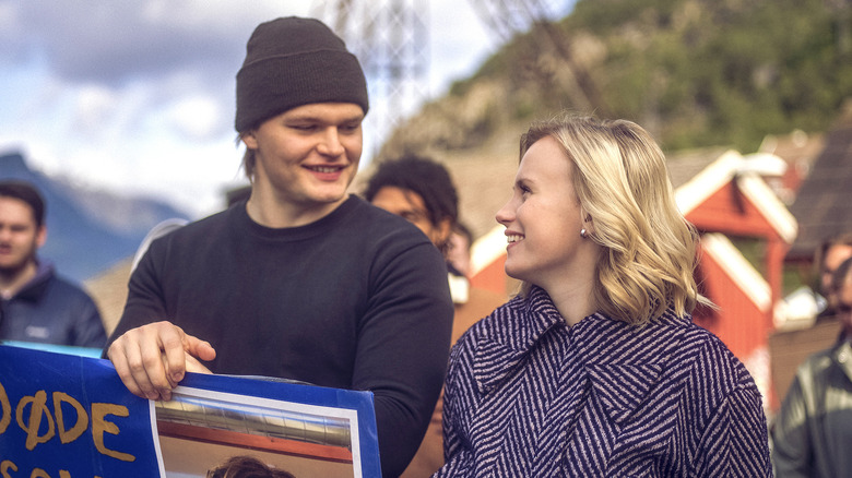 Magne and Gry smiling at each other at a protest