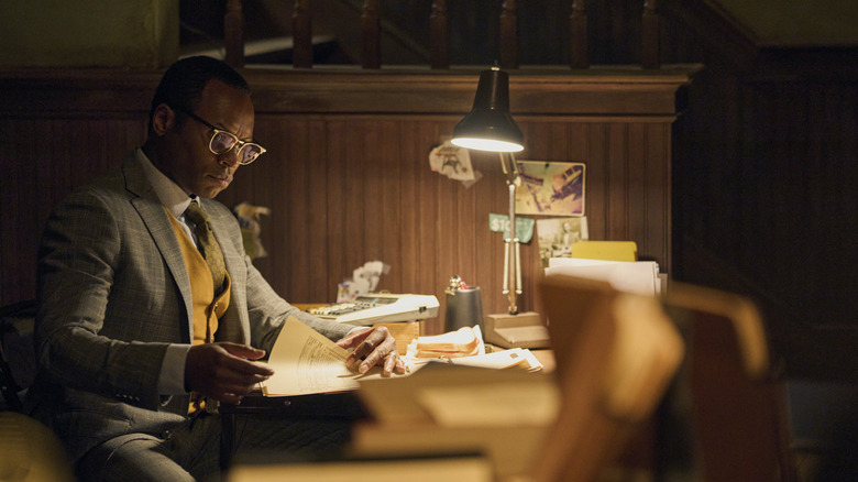 Detective Finlay reading at a desk