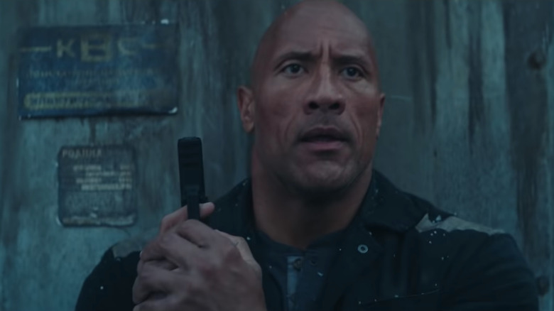 Dwayne Johnson holding gun