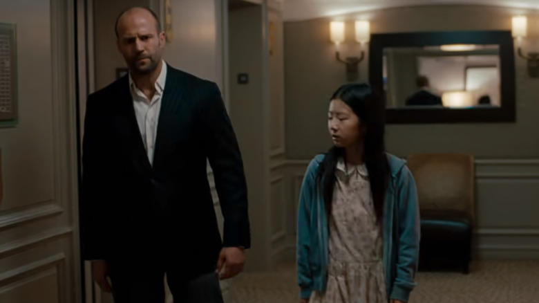 Luke and Mei walk through the hotel