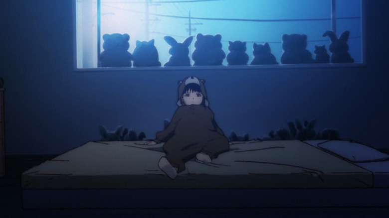 Lain lies on bed in bearsuit