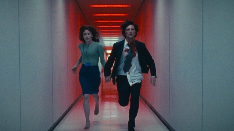 Mark and Helly run down a red hallway on Severance (2025)