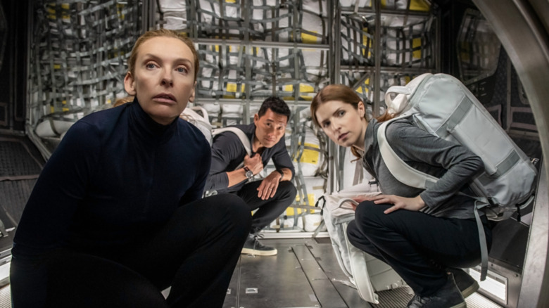 Marina, David, and Zoe kneeling in spaceship