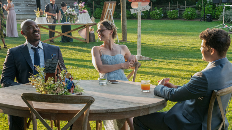 Winn, Kara, and James laughing at table