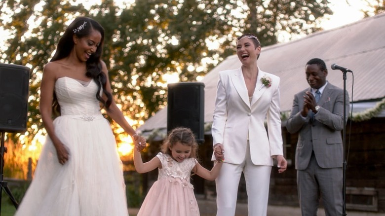 Alex and Kelly with Esme at wedding