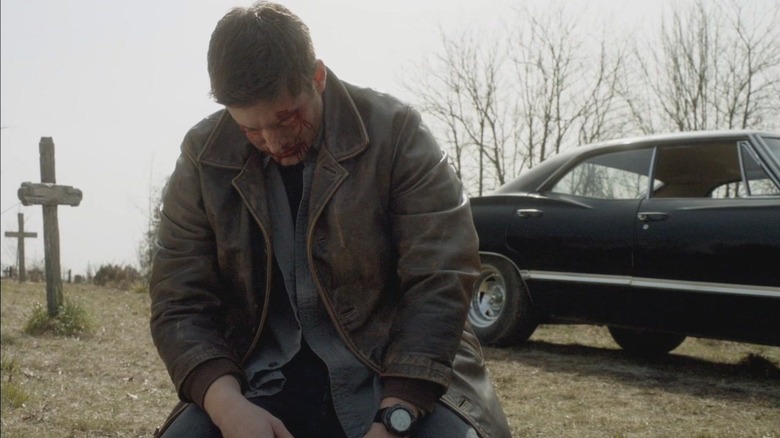 Dean kneeling on the ground