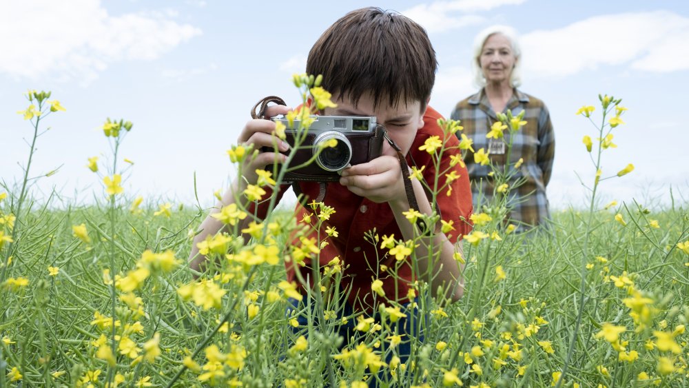 Cole takes a photo in Tales from the Loop